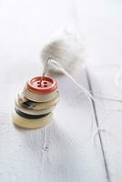 a pile of buttons on a white table photo