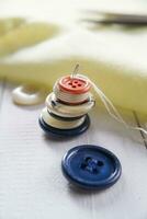 a pile of buttons on a white table photo