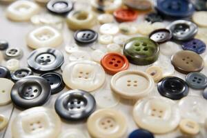 a pile of buttons on a white table photo
