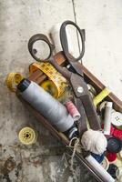 sewing supplies and buttons arranged on a white surface photo