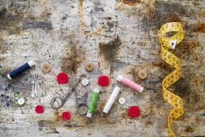 sewing supplies and buttons arranged on a white surface photo