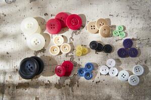 sewing supplies and buttons arranged on a white surface photo