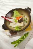 a plate with vegetables and a fork on a table photo