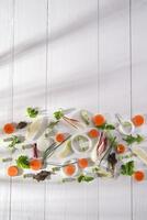 a white table with carrots, onions, celery and parsley photo