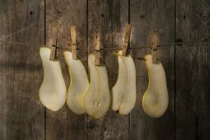 a group of five white peaches hanging on a clothesline photo