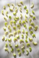 a white wall with a bunch of green apples photo