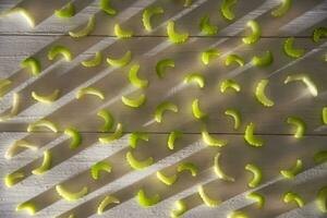 a bunch of green apples on a white surface photo