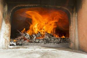 a close up of a fire burning in a fireplace photo