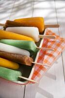 ice pops on a plate with orange and green stripes photo