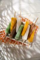 ice pops on a plate with orange and green stripes photo