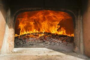 a close up of a fire burning in a fireplace photo