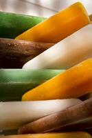 ice pops on a plate with orange and green stripes photo