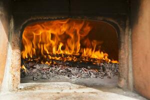 a close up of a fire burning in a fireplace photo