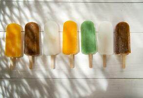 ice pops on a plate with orange and green stripes photo