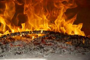 a close up of a fire burning in a fireplace photo