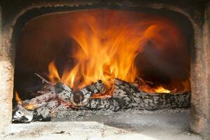 a close up of a fire burning in a fireplace photo