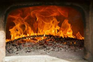 a close up of a fire burning in a fireplace photo