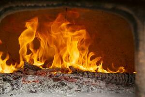 a close up of a fire burning in a fireplace photo