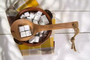 a wooden spoon with white cubes on it photo