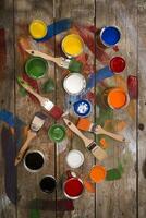 a table with paint cans and brushes photo
