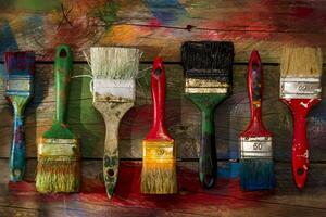 a table with paint cans and brushes photo