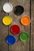 a group of paint cans with different colors photo