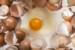 an egg is broken in half and surrounded by other eggs photo