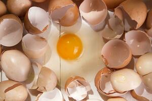 an egg is broken in half and surrounded by other eggs photo