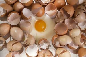 an egg is broken in half and surrounded by other eggs photo