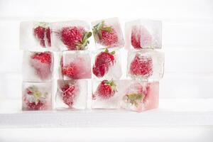 Ice cubes with strawberries photo