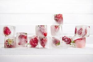 Ice cubes with strawberries photo