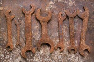 a group of rusty old tools sitting on a wall photo