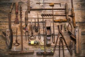 a group of rusty old tools sitting on a wall photo