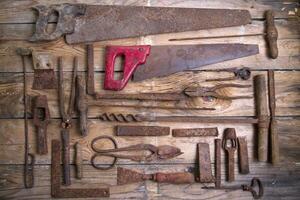 a group of rusty old tools sitting on a wall photo