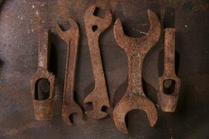 a group of rusty old tools sitting on a wall photo