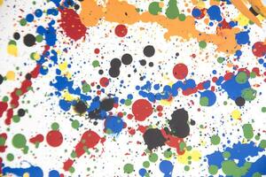 a colorful paint splattered surface with many different colors photo