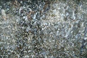 a close up of a granite surface with some black spots photo
