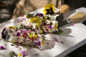 Goat cheese with edible flowers photo