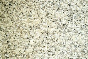 a close up of a granite surface with some black spots photo