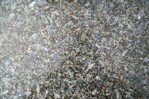 a close up of a granite surface with some black spots photo