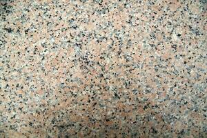a close up of a granite surface with some black spots photo