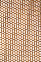 a close up of a metal mesh with holes photo