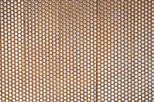 a close up of a metal mesh with holes photo