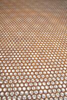 a close up of a metal mesh with holes photo