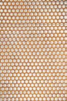 a close up of a metal mesh with holes photo