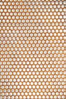 a close up of a metal mesh with holes photo