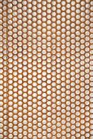 a close up of a metal mesh with holes photo