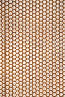 a close up of a metal mesh with holes photo