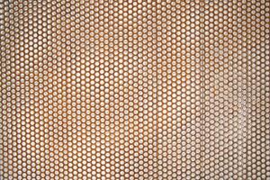 a close up of a metal mesh with holes photo