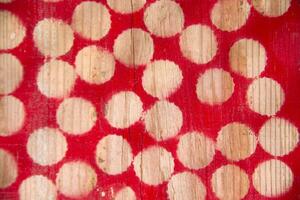 a red and white polka dot pattern on a wooden surface photo